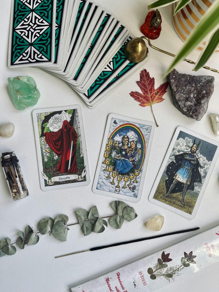 Mystical tarot spread with crystals and leaves, evoking fortune and introspection.